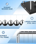 Close-up of Large Newtons Cradle Pendulum Desk Toy With 5 Beads Perpetual Motion Balance Balls Black Wooden Base and metal frame