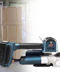 No Sweat Electric Strapping Tool For Pp Pet Straps positioned next to bundled boxes, showing electronic display and design.