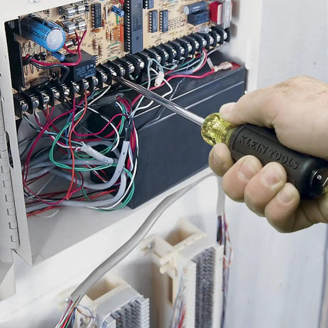 Using a 7 Piece Screwdriver Set With Non Slip Cushion Grip Handles And Tip Ident For Slotted And Phillips Drivers on a circuit board.