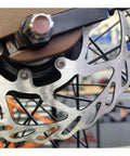 Close-up of Centerlock Disc Rotors 160mm 2-Pack With Lock Rings on bike wheel, aluminum alloy, for centerlock hubs, 1.8mm thick.