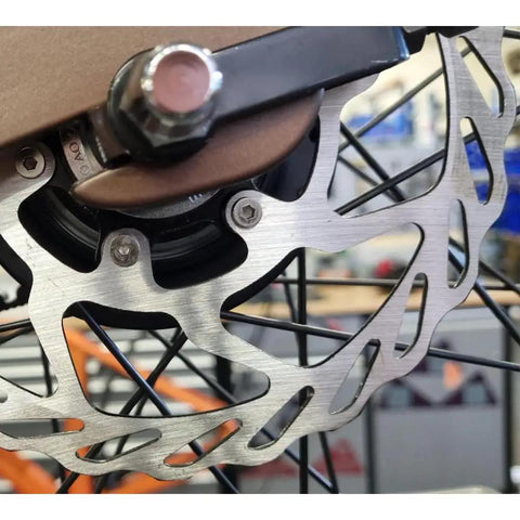 Close-up of Centerlock Disc Rotors 160mm 2-Pack With Lock Rings on bike wheel, aluminum alloy, for centerlock hubs, 1.8mm thick.
