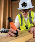 Worker using XL Chisel Tip Permanent Marker For Multi Surface Jobsite Use Black Ink on wood plank in construction setting