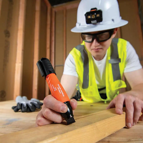 Worker using XL Chisel Tip Permanent Marker For Multi Surface Jobsite Use Black Ink on wood plank in construction setting