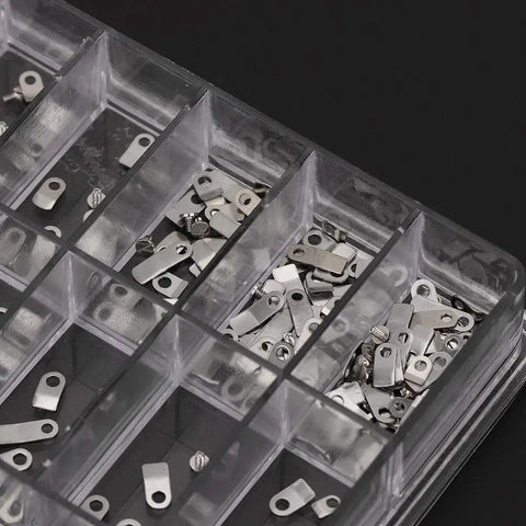 Assorted steel adapters and screws in a box from 12 Size Casing Clamp And Screw Set For Watch Repair Kit