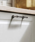 Vintage Antique Bronze Cabinet Handles And Drawer Pulls For Kitchen Cupboards in retro style on light cabinet door.