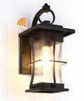 Dusk To Dawn Outdoor Wall Lantern With Sensor, Matte Black Porch Light, glowing against a white background