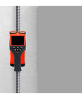 This Powerful Wall Scanner and Concrete Rebar Depth Finder Represents a Total Beast for Renovators, showing an orange handheld scanner on a wall.