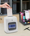 Built Tough Wall Mount Or Desk Time Clock Bundle With Bright Lcd Screen, punch card being inserted, office setting.