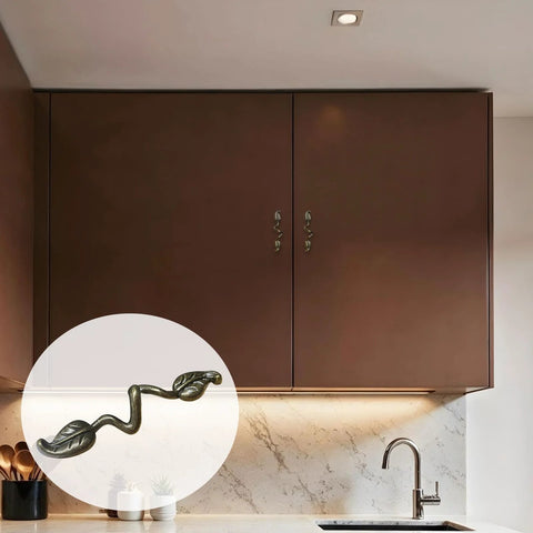 Leaf Shape Drawer Pull Handle Set In Vintage Bronze Finish installed on kitchen cabinets, with a close-up inset showing twig branch design.