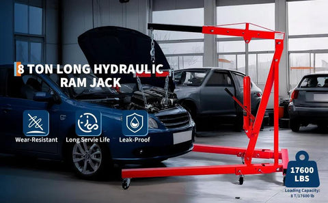 Red 8-ton engine hoist/crane with long hydraulic ram and wheeled base in a garage.