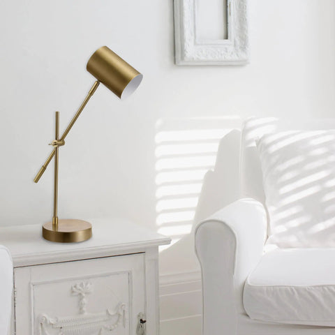 Desk Lamp In Matte Brass Finish With Adjustable Height And Balance Arm Inline Rocker Switch next to white armchair
