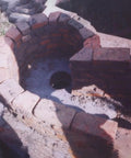 Circular brick structure for a hydro installation site with central outlet opening, potential setup for 5000W Three Phase Axial Flow Hydro Generator Set 400V