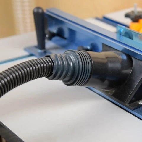 10 Ft Flexible Vacuum Hose Dust Collection Kit connected to woodworking tool's dust port on a miter saw in a shop.