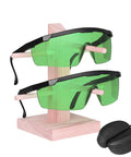 Green Laser Safety Glasses 2 Pack For UV And Infrared Protection With Adjustable Frames displayed on stand with hard case