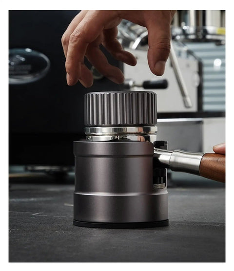 Close-up of Adjustable Aluminum Alloy Espresso Portafilter Tamping Station Boss Level Holder with hand, ensuring perfect shot alignment.