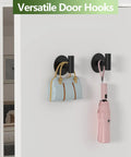 Self-Adhesive Rust-Resistant Stainless Steel Coat Hooks Heavy-Duty No-Drill Wall Hangers for Towels Robes Coats Hats Black 2 Pack Ideal for Bathrooms Kitchens and Hotels with bag and umbrella.