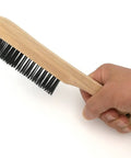 Person holding a 10 inch wire brush for slag removal with black bristles and wooden handle, part of Heavy Duty Welding Chipping Hammer set.
