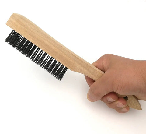 Person holding a 10 inch wire brush for slag removal with black bristles and wooden handle, part of Heavy Duty Welding Chipping Hammer set.