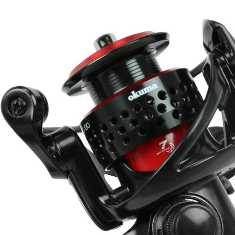 Close-up of Ceymar Spinning Reel Size 10 with five pound max drag, featuring black and red design with seven ball bearings.