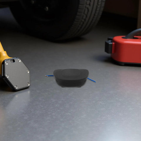 Self Activating Aerosol Car Fire Extinguisher Heat Triggered Auto Engine Bay Suppression Gear on garage floor with tools.