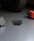 Compact 30 Gram Self Activating Aerosol Fire Extinguisher For Trucks And Cars with heat-triggered design on workshop floor.