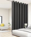 Extra Wide Room Divider Curtain 96X150 Inch For Total Light Blocking And No Sweat Rod Prep With Heavy Duty Metal Grommets in dark grey hanging in a modern living space.