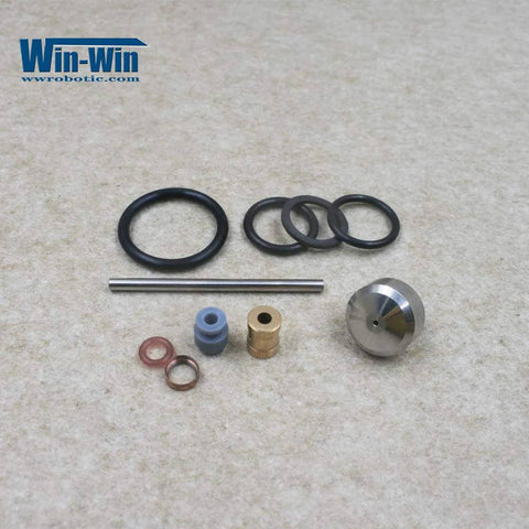 Front view of Win-Win waterjet maintenance kit components: O-rings, seals, metal rod, brass fittings, blue spacer.