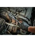 Hand using the Total Badass 1/2 Inch Drive Ratchet Socket Set 47 Piece on car engine parts for repairs.