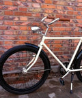 Bicycle with Old School 3 LED Bicycle Front Light With Bracket next to a brick wall, featuring vintage headlamp for night riding