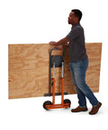 Man using Next Gen Panel Carrier and Panel Dolly, Table Saw Feed Stand with Adjustable Height, moving 4x8 sheet with ease.