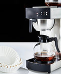 Coffee maker with glass carafe and stack of Large Flat Bottom Coffee Filters Tall Walled 9.75 Inch Wide 4.25 Inch Tall 2.75 Inch Sides