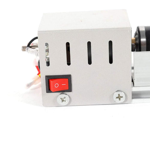Side view of mini wood lathe head with metal housing, vent slots, and red power switch