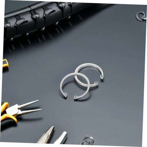 5 Piece Stainless Steel C Clip Retaining Ring Kit With Internal And External Circlips Snap Rings For Secure Attachment And Easy Installation No Fuss For DIY Projects Machinery And Auto Repairs, showing tools and tire in background