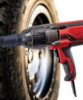 Heavy Duty One Half Inch Extreme Torque Impact Wrench With Rubber Nosepiece All Metal Gear Construction 1050 Ft Lbs Breakaway Torque Corded Power A True Workhorse For Tough Job Sites in action on a tire