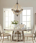 Geometric Orb 6-Light Farmhouse Chandelier with Stardust Finish hanging over dining table, rustic oak frame visible.
