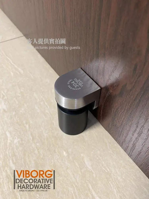 Side view of Beefy Heavy Duty Stainless Steel Floor Mount Magnetic Pop Up Door Stop With Solid SUS304 Casting, installed on a wooden door.