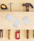 Beefy Flat Corner Brackets Set For Easy Connection And Secure Fastening Stainless Steel Mending Plates on wooden surface with tools