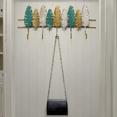Heavy Duty Wall Mounted Coat Rack For Entryway And Office Straight Up Sturdy Iron Build with leaf design holding bags.