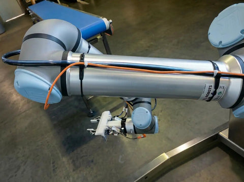 Outdoor UV Resistant Rubber Cable Zip Tie Mount Kit used on industrial robot arm with attached cables.
