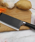 Ciieeo stainless steel crinkle potato cutter with black textured handle on wooden cutting board