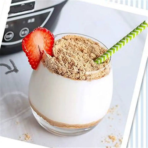 Delicious yogurt topped with crushed graham crackers and a strawberry, served in a clear glass for a healthy treat.