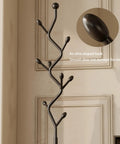 Close-up of Tree Shaped Coat Rack With Eight Hooks Heavy Duty Freestanding Metal Coat Tree On Cast Iron Base, olive-shaped hook detail