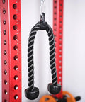 Heavy Duty Tricep Rope Attachment For Cable Machines 27 And 35 Inch Nylon Braided Rope With Solid Rubber Ends Universal Gym Compatible Pulldown Accessory Builds Triceps Biceps Back Shoulders Abs Two Color Black Red hanging on red exercise equipment.