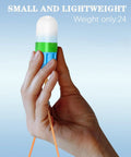 Hand holding small blue and green Underwater Signal Light For Diving IPX8 Submersible Beacon With Constant And Flashing Modes.