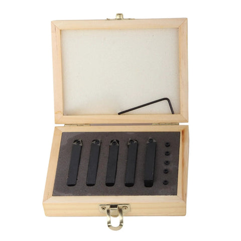Carbide turning tool set in wooden box with five black blades and small inserts