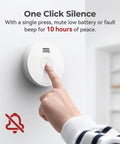 Hand pressing the test button on a Top Shelf Smoke Detector With Ten Year Sealed Lithium Battery for quick silence.