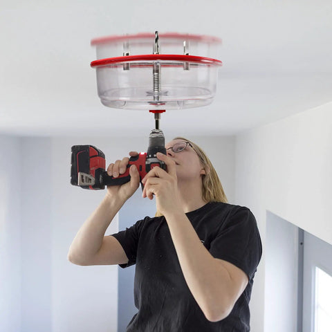 Person using Adjustable Hole Saw Cutter Kit From One And Five Eighths Inch To Eight Inches With Twin Blade And ABS Dust Shield for ceiling cutout
