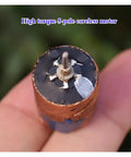 Close-up of Mini Coreless DC Motor 22mm By 33mm With Dual Shaft Beefy Torque NdFeB Magnets 5 Pole Rotor held in hand