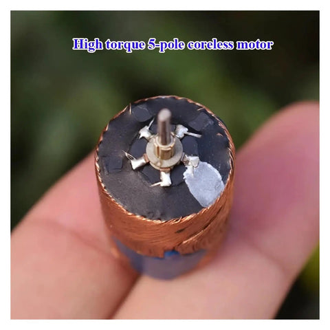 Close-up of Mini Coreless DC Motor 22mm By 33mm With Dual Shaft Beefy Torque NdFeB Magnets 5 Pole Rotor held in hand