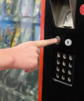 Secure Your Setup With This Sick Black Metal Vending Machine Lock Assembly With Tubular Keys For Snack Candy Dispensers Ensuring Quick Fixes And No Sweat Maintenance To Keep Your Stock Safe And Business Rolling Smoothly Right Now. Black metal vending machine lock on snack dispenser panel, with finger pressing the lock.